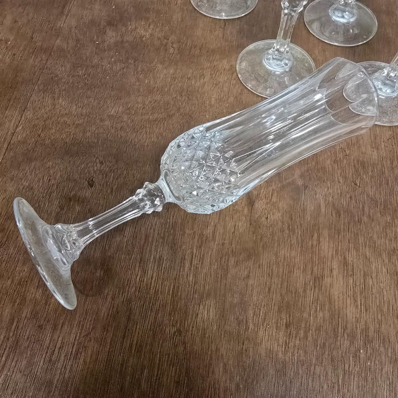 Détail du calice de la flûte vintage en verre, avec motif en relief élégant et brillant.