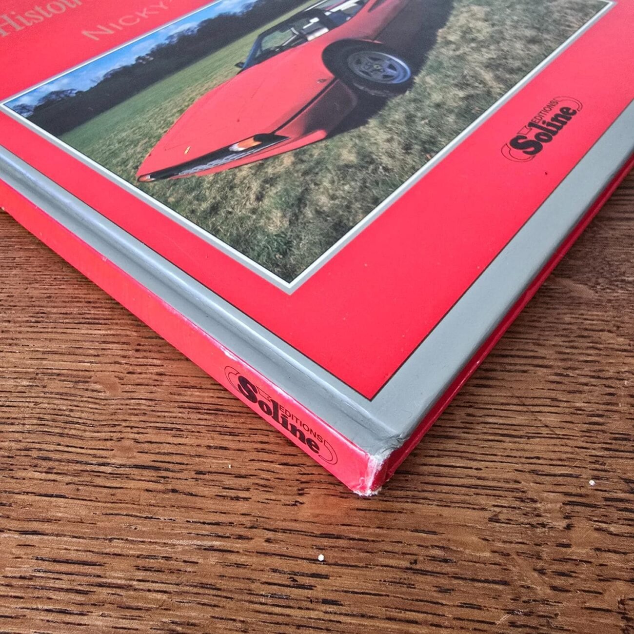 Gros plan sur le coin bas de la couverture rouge du livre Ferrari